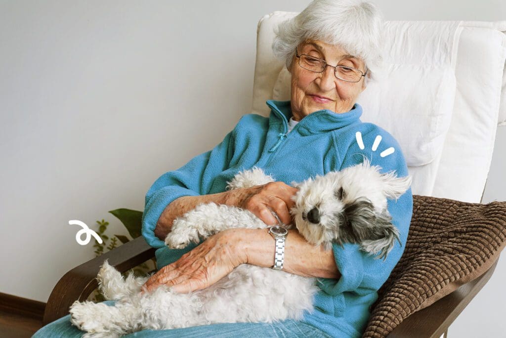 persona mayor abrazando a un perro de terapia